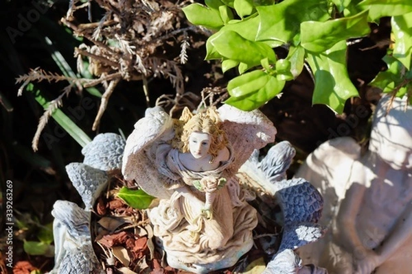 Obraz A statue surrounded by green leaves!