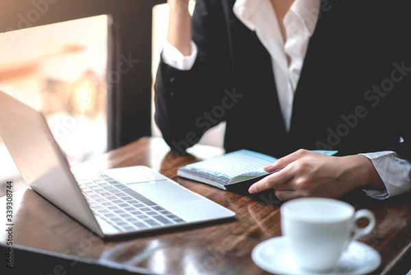 Obraz Businessman analyzing and recording information about financial business