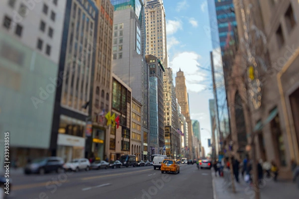 Fototapeta Street view of light traffic in a New York City street. Shot with manual Tilt Shift lens for selective focus effect.