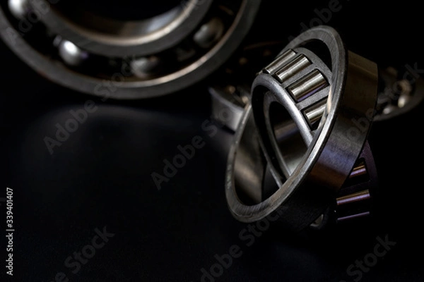 Fototapeta Closeup of Tapered roller bearing with copy space for your text on black background. Spare part of mechanical .