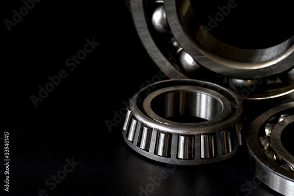 Fototapeta Closeup of Tapered roller bearing with copy space for your text on black background. Spare part of mechanical .
