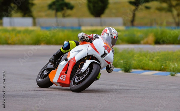 Obraz Motorcycle practice leaning into a fast corner on track