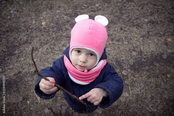 Obraz Funny little girl looks at the camera and smiles. Wide-angle lens distortion