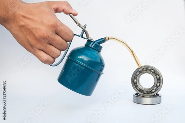 Fototapeta Oiler handle and ball bearings
isolated on a white background