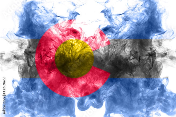 Fototapeta The national flag of the US state Colorado in against a gray smoke on the day of independence in different colors of blue red and yellow. Political and religious disputes, customs and delivery.