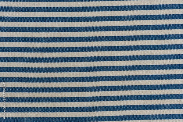Fototapeta Nautical textile texture for background. Close up of a marine textile texture with blue and white stripes.