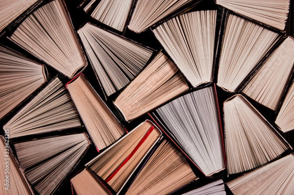 Fototapeta Many old books in a book shop or library. Shallow DOF