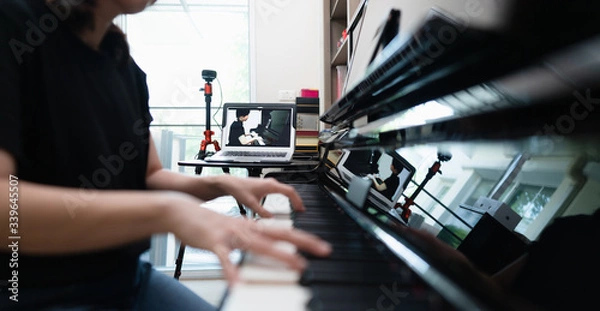 Fototapeta Online class or E-learning piano lessons during Coronavirus spread out or covid-19 crisis situation, students pupils having piano online class solution or alternative way for social distancing.