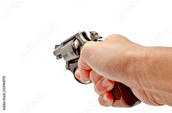 Obraz A hand holding a revolver handgun aiming toward
