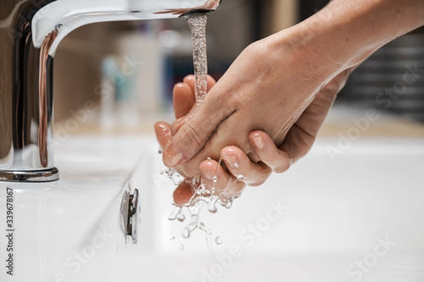 Fototapeta Woman washing her hands