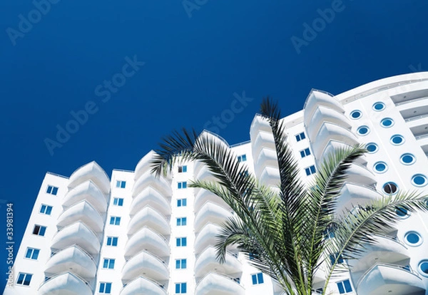 Obraz White residential building and palm tree