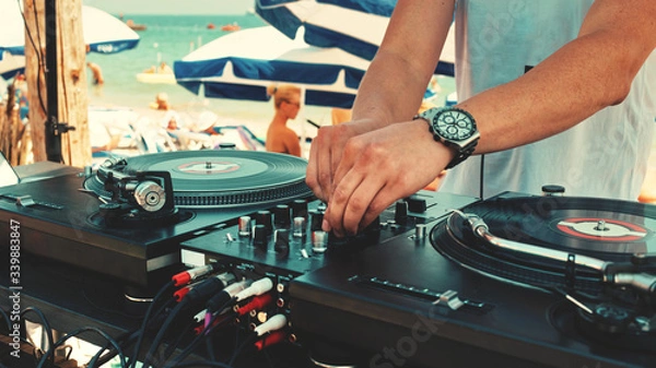 Obraz Dj plays music at the beach party on a sunny summer day