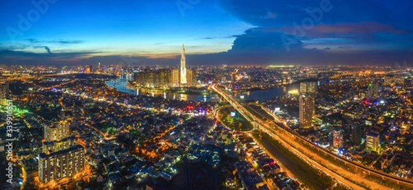 Fototapeta Top view aerial of center Ho Chi Minh City and Saigon bridge with development buildings, transportation, energy power infrastructure. Financial and business centers in  Vietnam. View from District 2