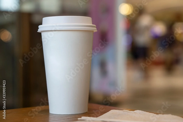 Fototapeta Mock-up of without Cup sleeve White paper hot coffee cup in Coffee shop./Food packaging pattern.