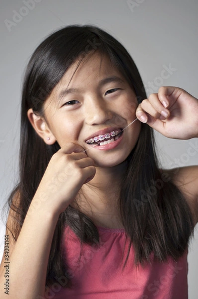 Obraz Girl flossing teeth