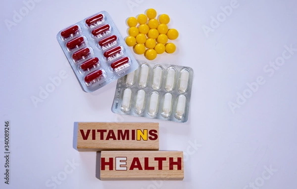 Fototapeta A lot of vitamins on the white table. Vitamins for health.