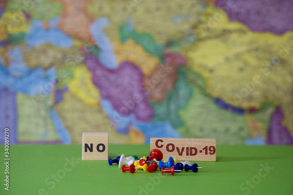 Fototapeta Stop the Covid-19 pandemic against the background of a geographic map.