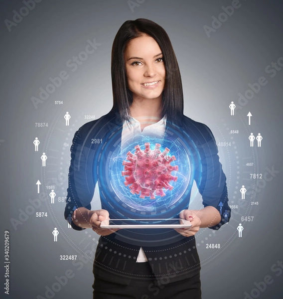 Fototapeta A young girl is holding a tablet. Projection of a virus cell with a hologram of a map of North America.
