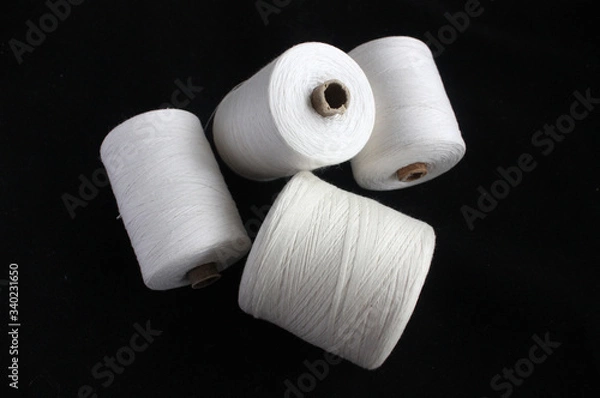Obraz spools of thread on a black background