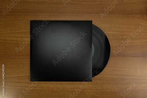 Obraz Empty Black Vinyl disk case with vinyl piece in a wood background for mockup purposes