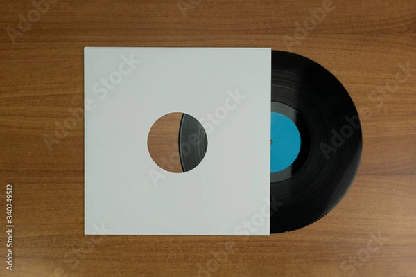 Obraz Empty white paper Vinyl disk case and black vinyl a wood background for mockup purposes