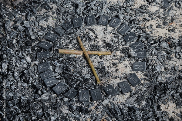 Fototapeta Norse rune Nautiz on ashes backgorund inside the circle of 24 Norse runes.