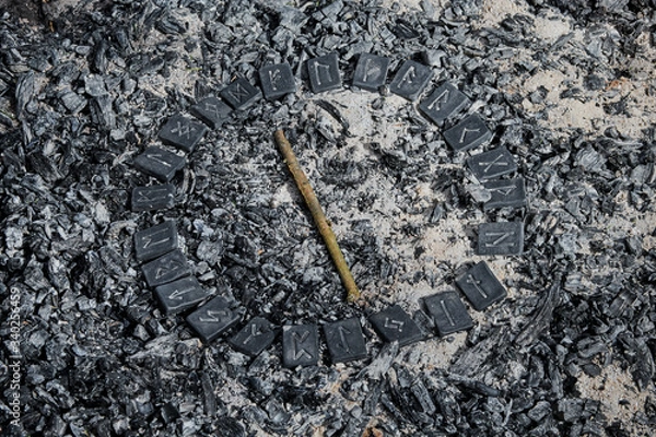 Fototapeta Norse rune Isa on ashes backgorund inside the circle of 24 Norse runes.