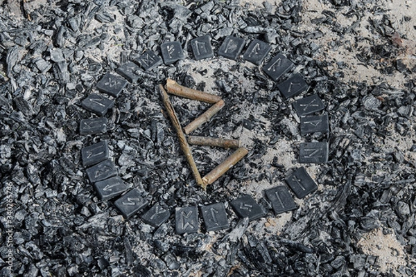 Fototapeta Norse rune Berkana on ashes backgorund inside the circle of 24 Norse runes.