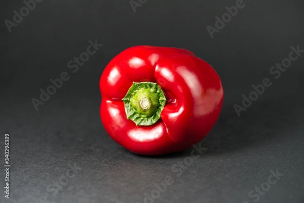 Obraz red bell pepper on black background.