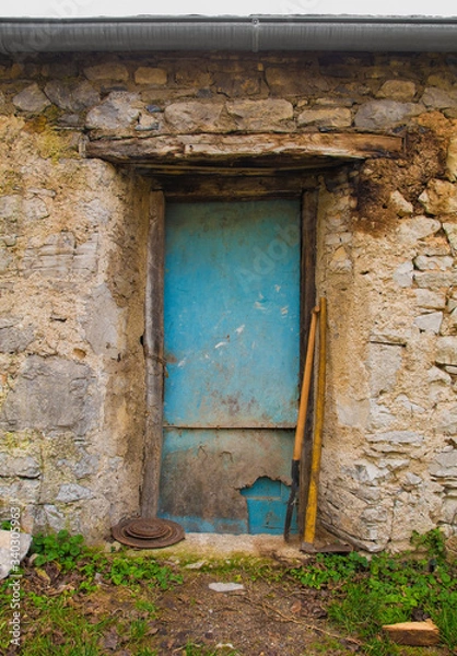 Fototapeta An old door in a derelict building in the historic hill village of Stanjel in the Komen municipality of Primorska, south west Slovenia.
