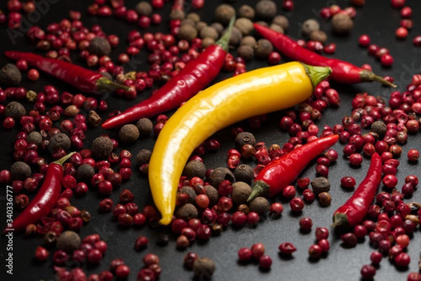 Obraz Red and yellow Pepper on a black background.