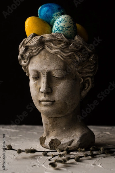 Obraz Antique statue of a girl and Easter painted eggs