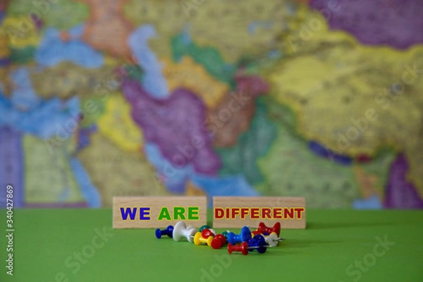 Fototapeta Different colors of office supplies against the background of the geographical map of the world