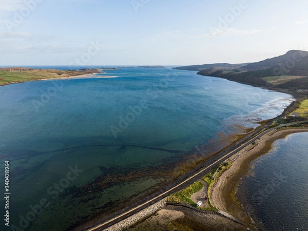 Fototapeta Aerial drone photo of Kyle of Tongue which is a shallow sea loch in northwest Highland, Scotland, in the western part of Sutherlan. Cars standing on a parking near road.