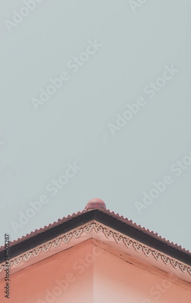 Obraz The roof of a home  on a minimalistic sky background.