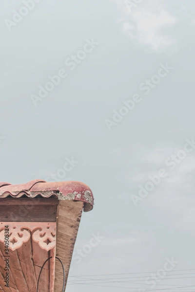 Obraz The roof of a home  on a minimalistic sky background.