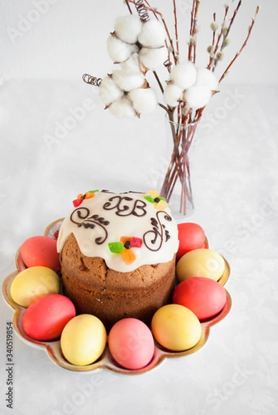 Fototapeta Easter cake with colored eggs and a vase