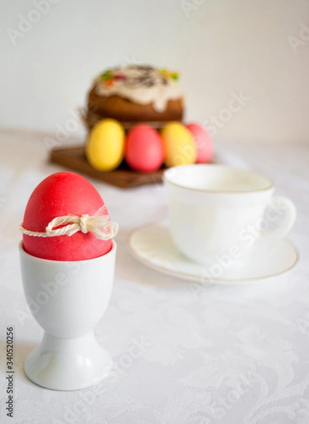 Fototapeta Easter table with a red egg in the foreground