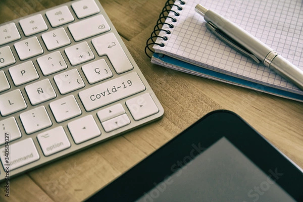 Fototapeta Keyboard with the covid-19 button. Concept for any illustration of teleworking or teleworking, home workers by coronavirus.