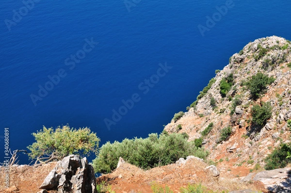 Fototapeta Magnificent view of the clear blue sea from the high mountain.