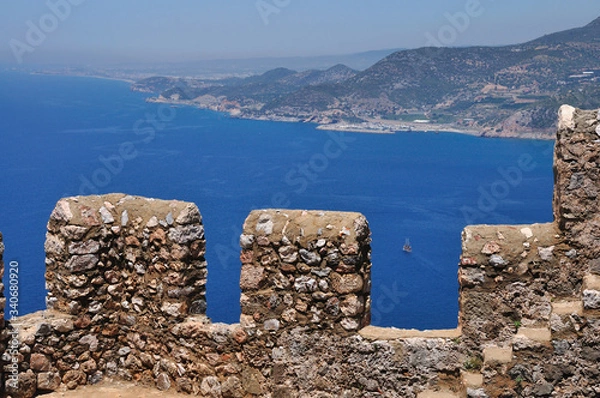 Fototapeta Beautiful view of the clear blue sea from the high mountain. There 's a fortress wall on the mountain.