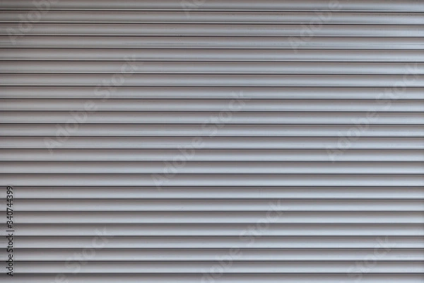 Fototapeta texture of corrugated metal sheet, white or grey slide door Old roller shutter texture for background