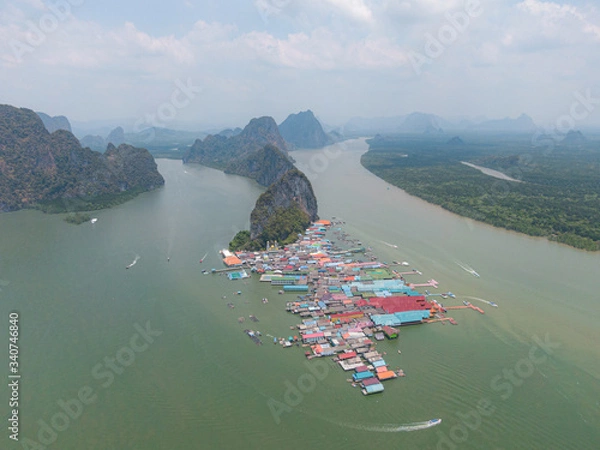 Obraz Drone shot of Aerial view over Ko Panyi floating village in south of Thailand. Ko Panyi is a fishing and muslim village in Phang Nga Province. With small islands as background.