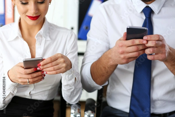 Fototapeta Group of people look at phones in arms at office closeup. Read news mania send sms chat addict use electronic bank modern lifestyle idea job plan colleague share blog tweet web search concept