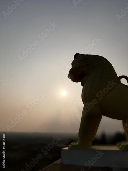 Obraz lion statue at sunset