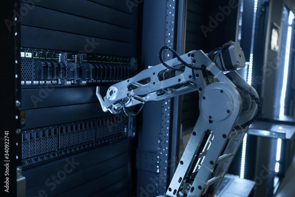 Obraz Robot arm is manually operating data center hardware