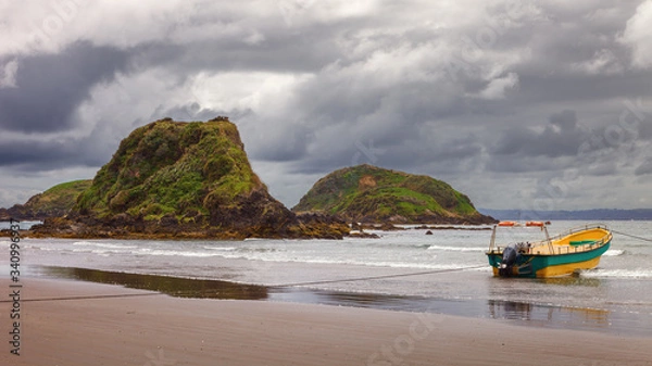 Fototapeta Moored boat used to take tourists to see penguins in the protected area of the Punihuil islets in the island of Chiloé, Chile