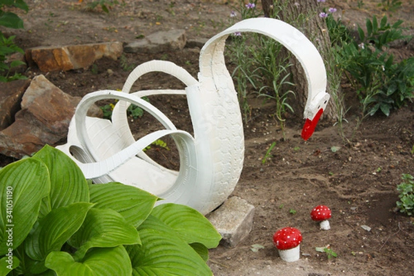 Fototapeta The idea of crafts for children in the garden from the tire. Swan made of rubber. Recycling.