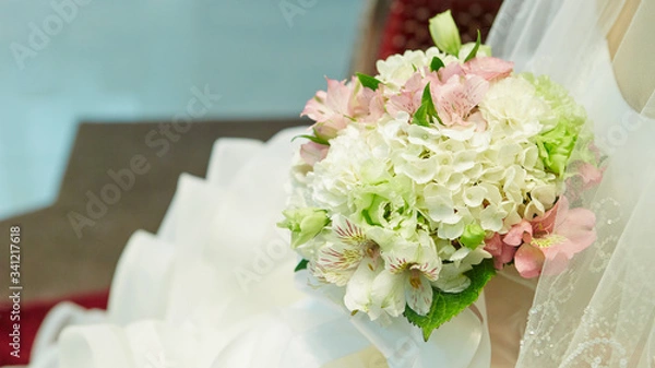 Obraz Bride in wedding dress holding flower bouquet 