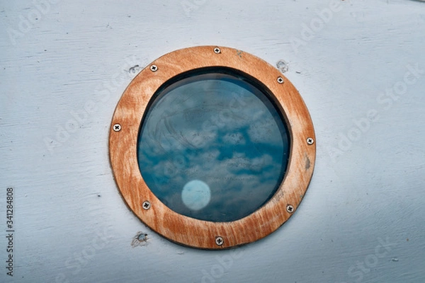Fototapeta ship window or porthole on white wooden wall